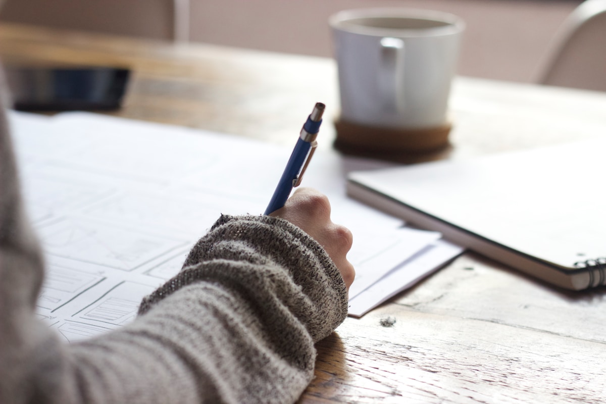 Person writing on a document